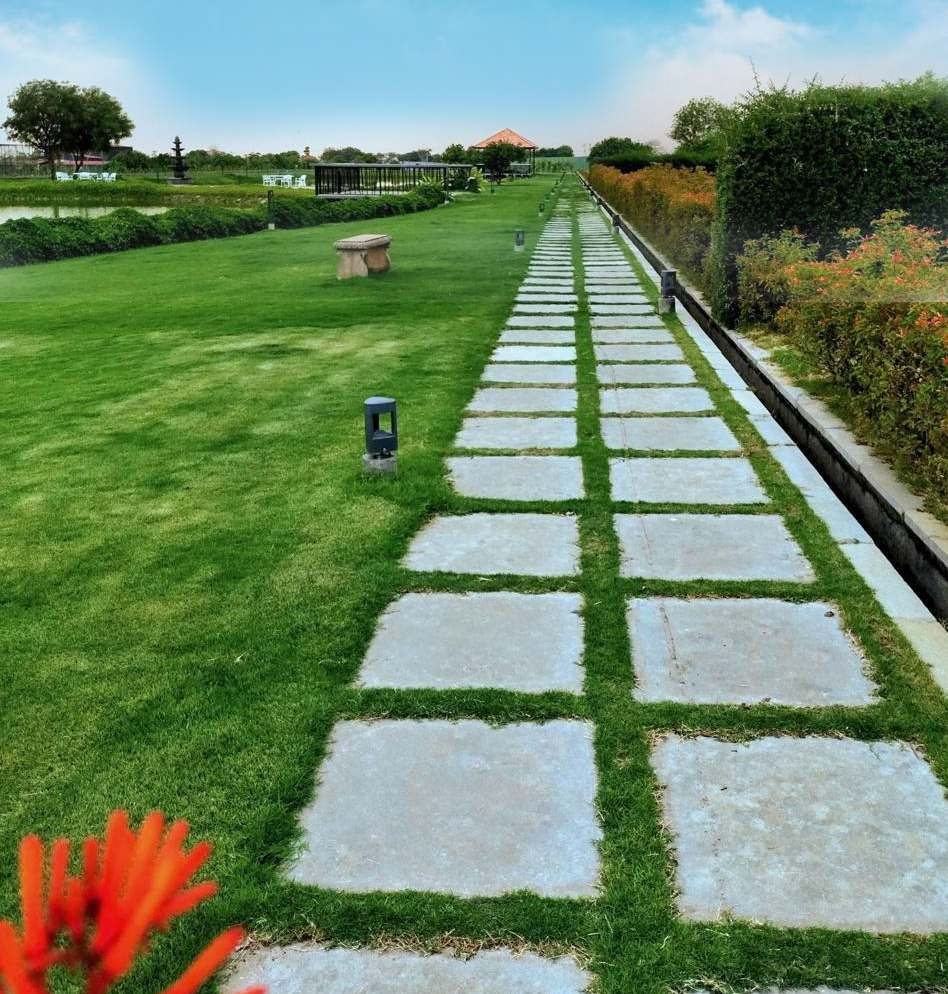 Stone-paved avenue through the manicured lawns of Villaggio farmland community